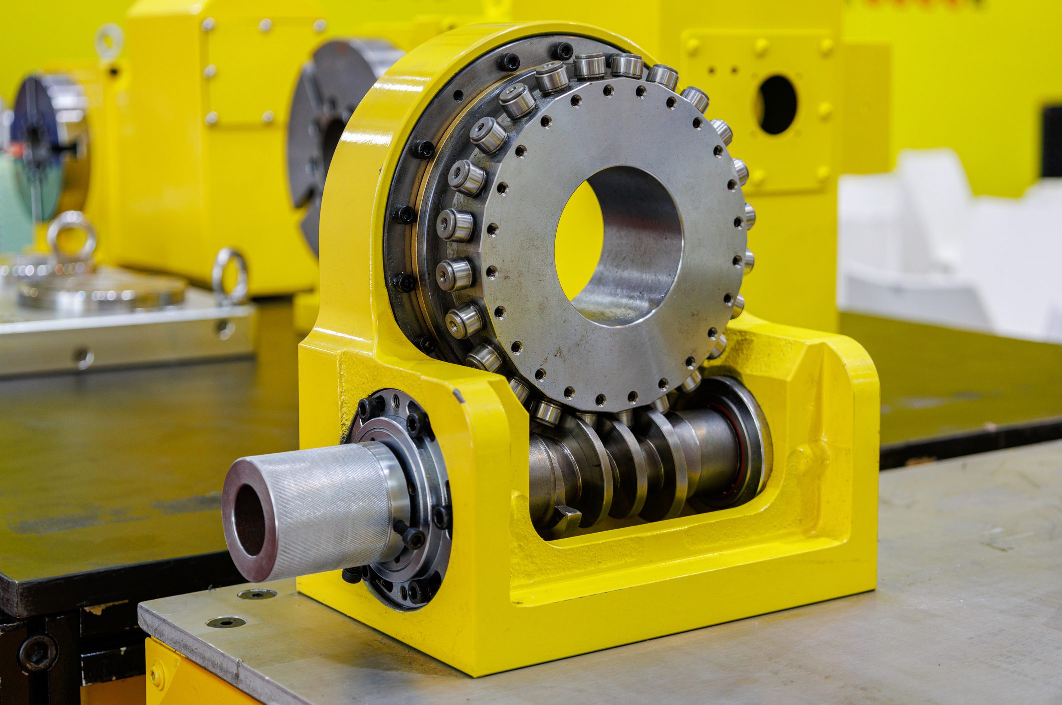 Machine tool transmission close-up Yellow industrial rotary bearing assembly.