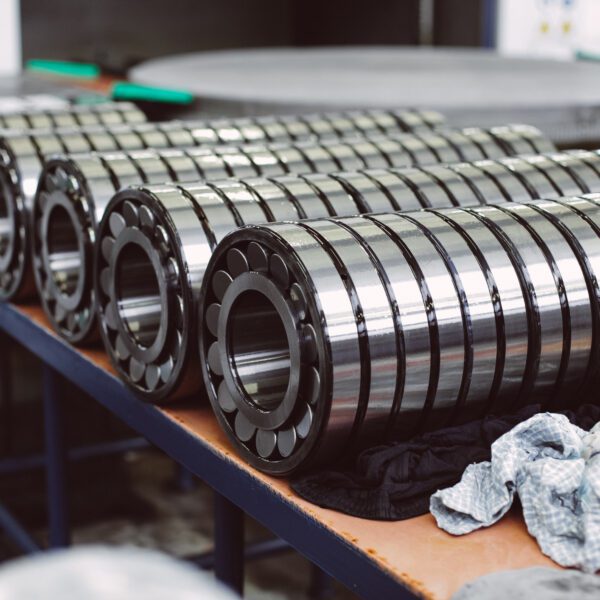 Industrial barrel bearings sorted on work table Stacks of industrial roller bearings.